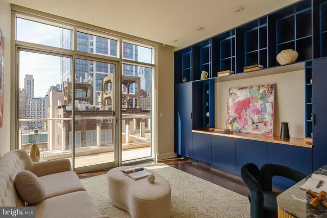 a living room with furniture a fireplace and wall paintings