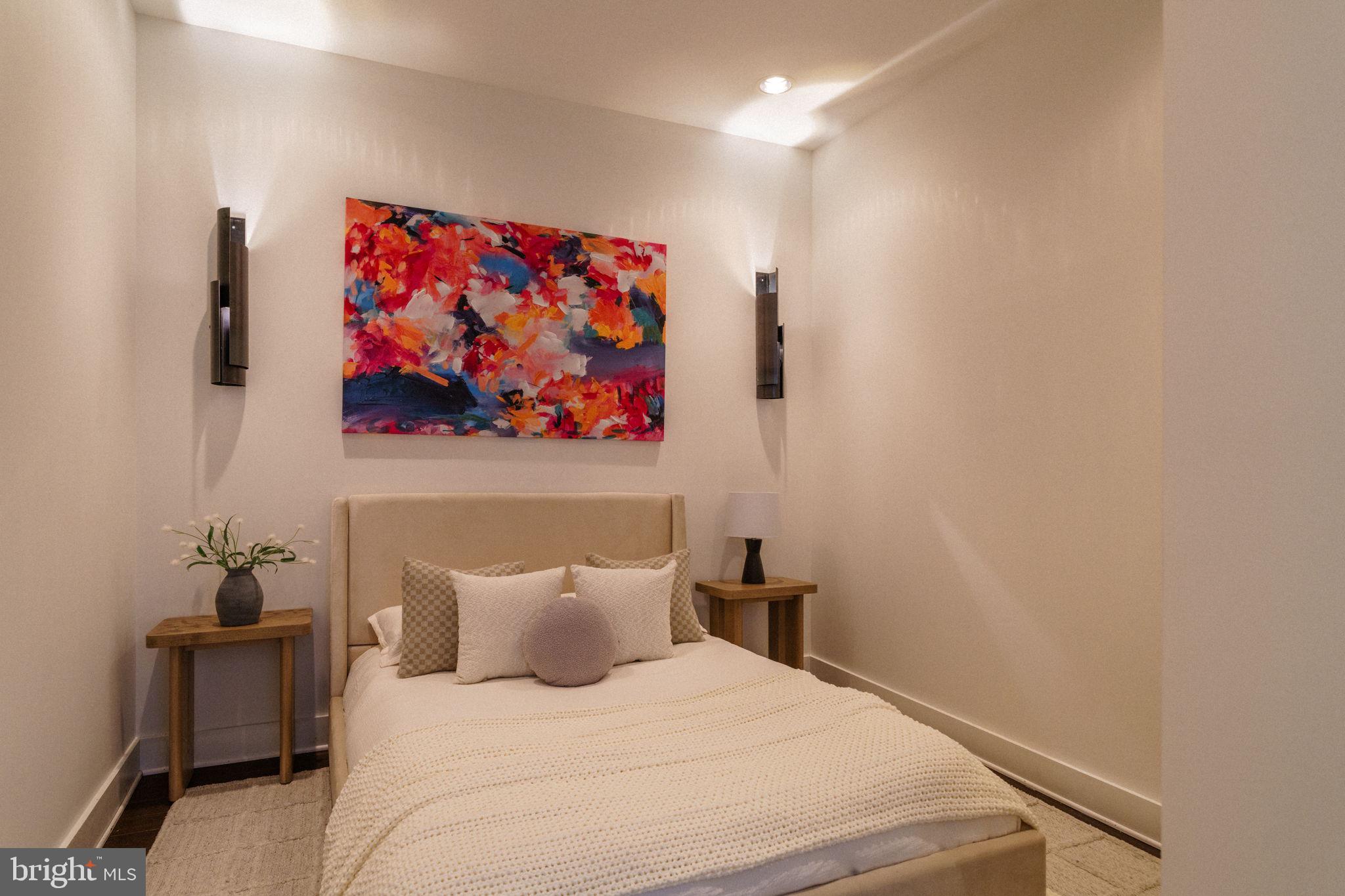 1111 Locust Street, Unit PH10D Philadelphia, PA 19107 - Photo 10 of 31 a bedroom with a bed and a painting on the wall