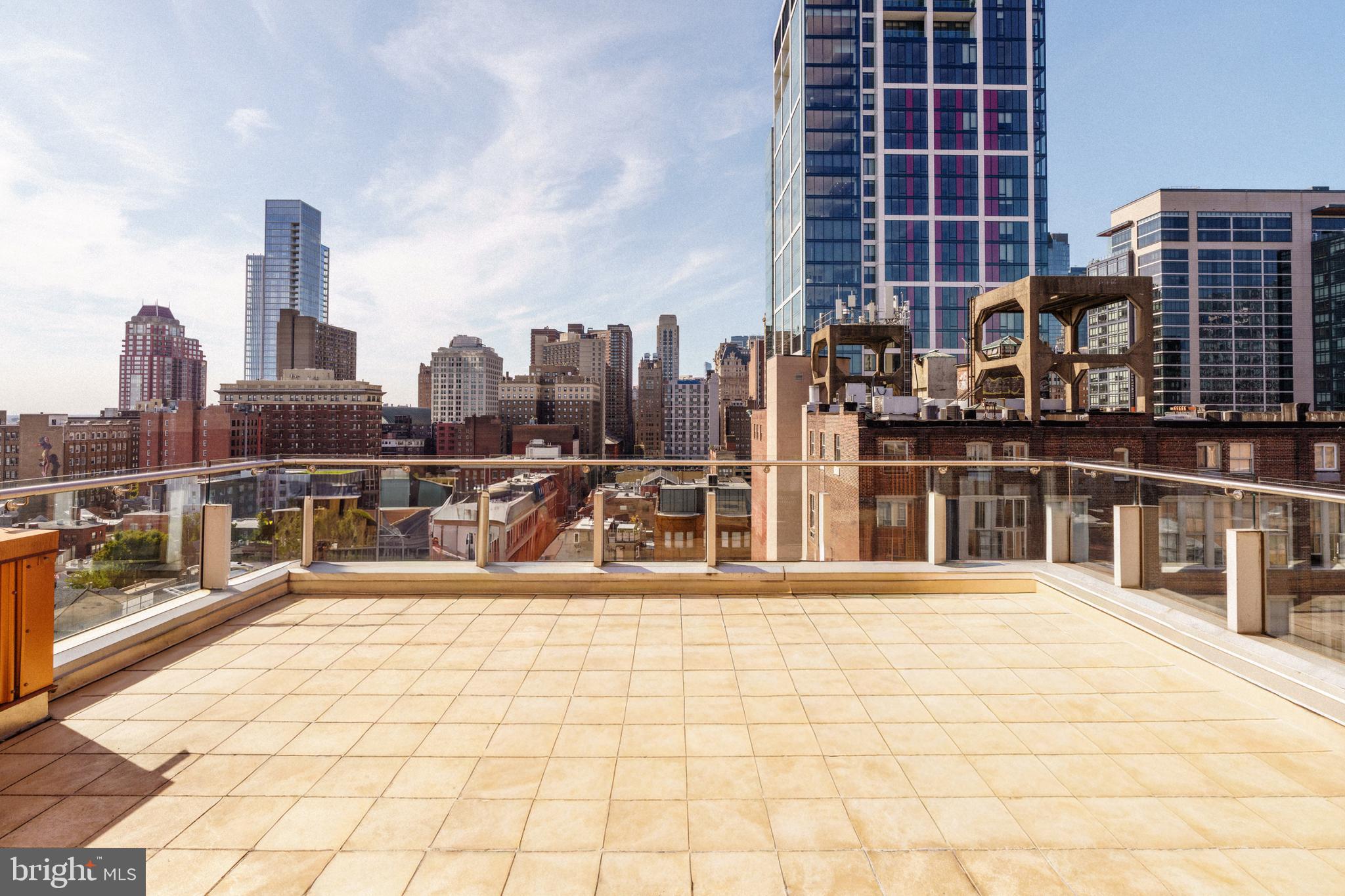 1111 Locust Street, Unit PH10D Philadelphia, PA 19107 - Photo 12 of 31 a swimming pool with outdoor seating and city view