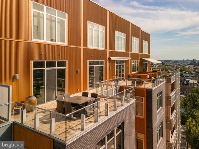 a swimming pool with outdoor seating and city view