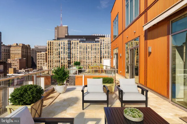 a building outdoor space with patio furniture and wooden floor