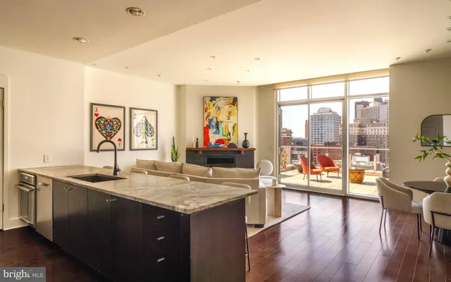 a view of a balcony with wooden floor and outdoor seating