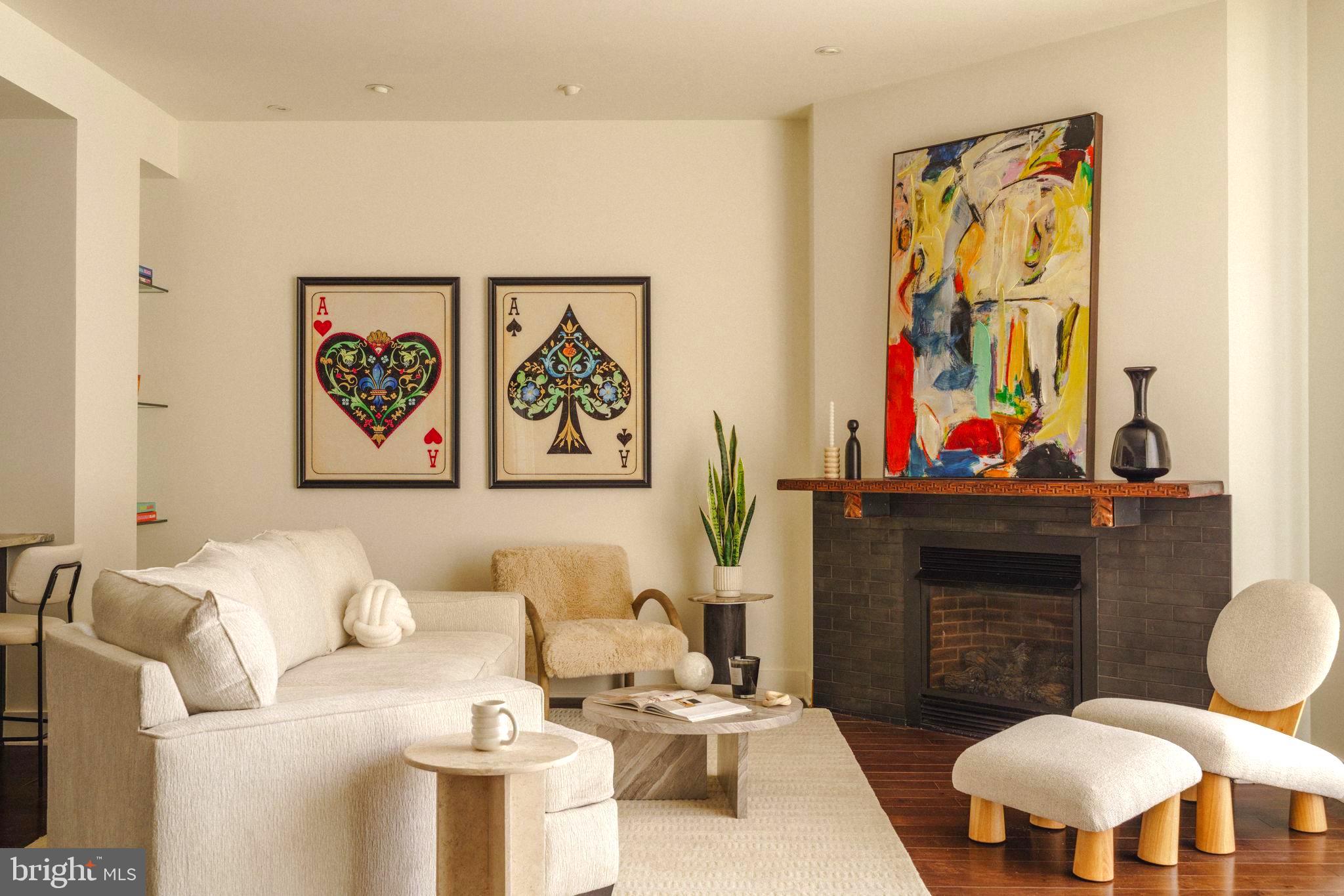 1111 Locust Street, Unit PH10D Philadelphia, PA 19107 - Photo 28 of 31 a living room with furniture a fireplace and wall paintings