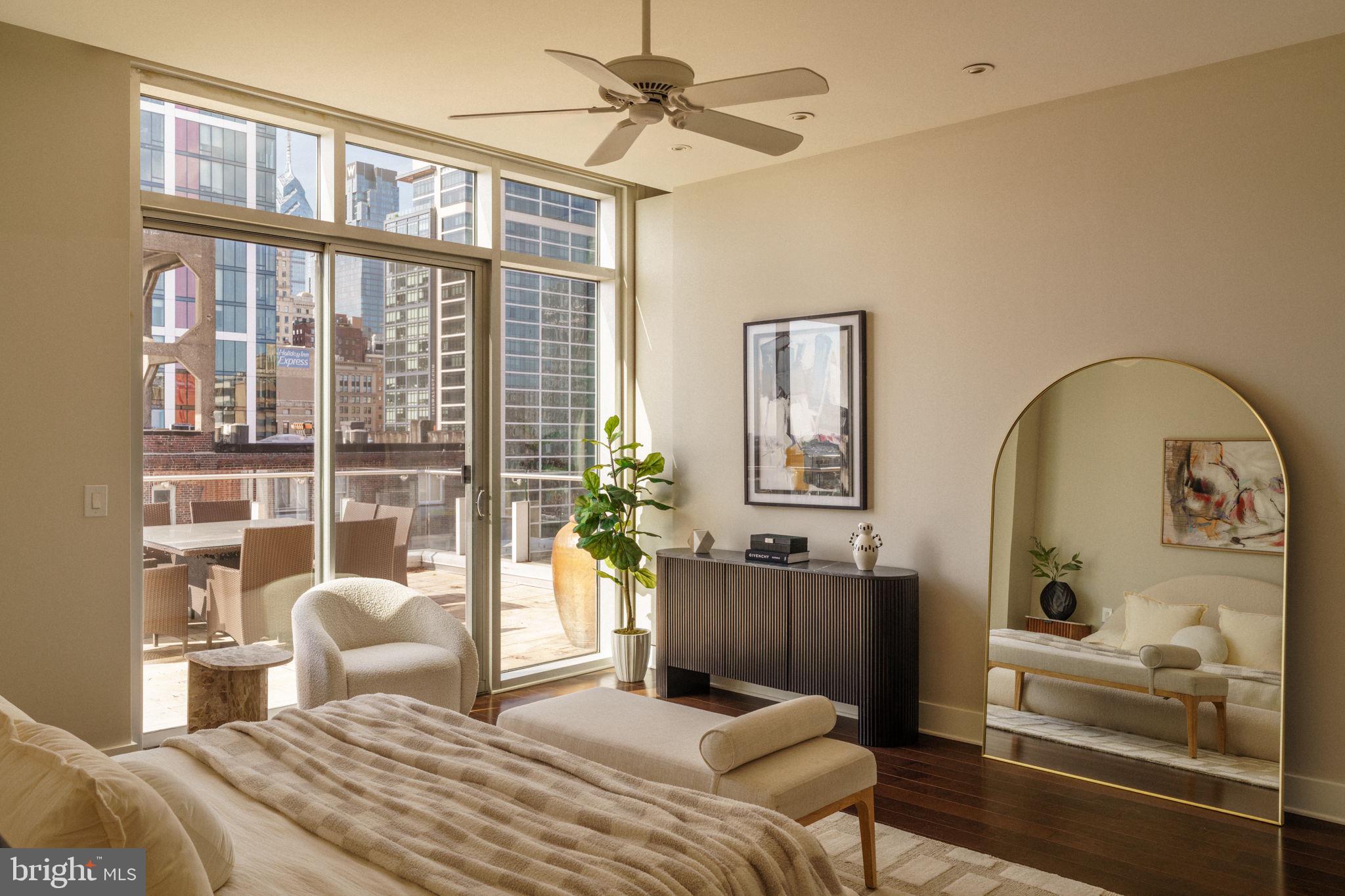 1111 Locust Street, Unit PH10D Philadelphia, PA 19107 - Photo 6 of 31 a bedroom with a balcony a bed and a chandelier