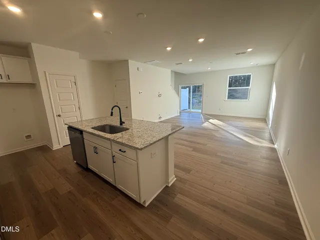 a kitchen with sink cabinets and wooden floor