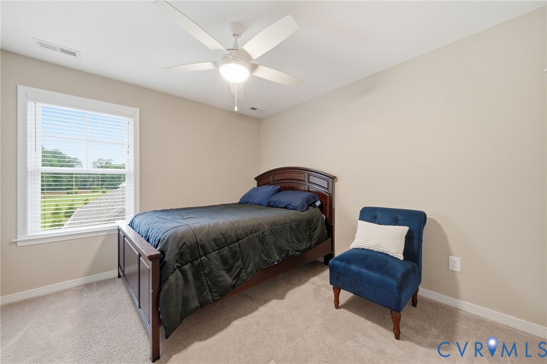 7598 Rural Point Road Mechanicsville, VA 23116 - Photo 27 of 41 a spacious bedroom with a bed and a window