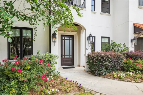 a front view of a house having a garden