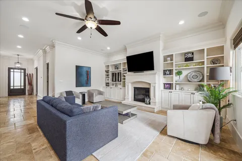 a living room with furniture a fireplace and a flat screen tv