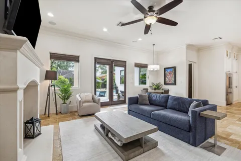 a living room with furniture ceiling fan and a window