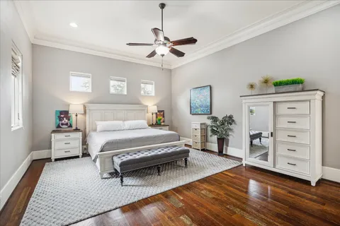 a spacious bedroom with a bed and a dresser