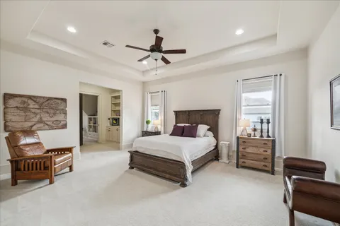 a spacious bedroom with a bed and furniture