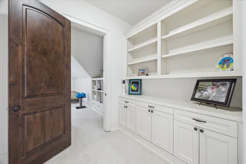 a view of cabinets with racks on the wall and white cabinets