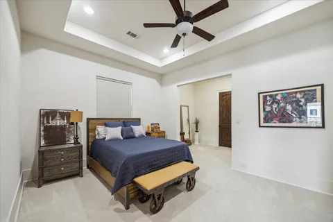 a bedroom with a bed and ceiling fan