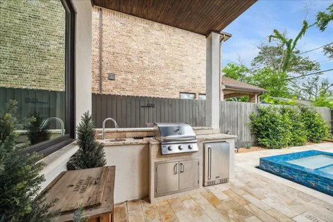 a view of a kitchen with a stove top oven and potted plants