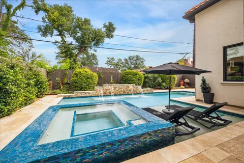 a view of a pool with chairs