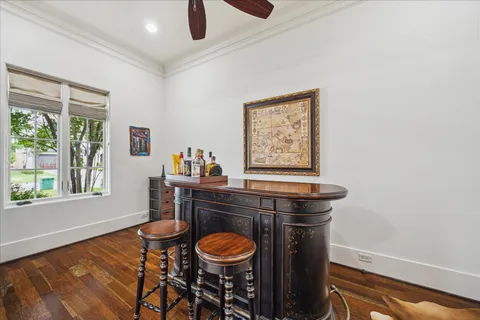 a dining room with a window and wooden floor