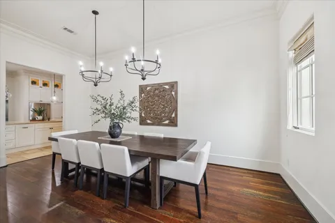 a view of a dining room with furniture wooden floor and chandelier