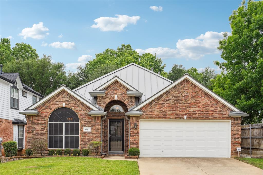 3671 Smoke Tree Trail Fort Worth, TX 76040 - Photo 1 of 1 View of front of house with brick siding, driveway, a garage, a front yard, and board and batten siding