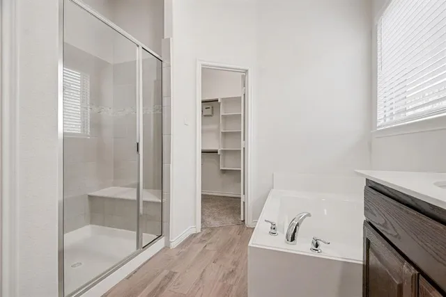 a bathroom with a tub shower and sink