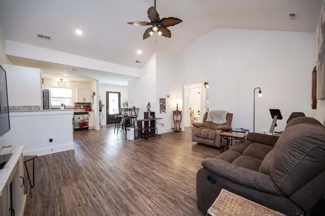 a living room with furniture and wooden floor