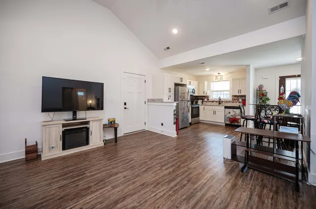 a living room with furniture and flat screen tv