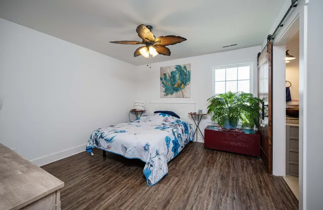 a bedroom with a bed and a potted plant