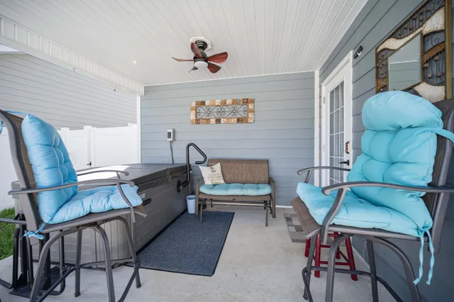 a backyard of a house with table and chairs