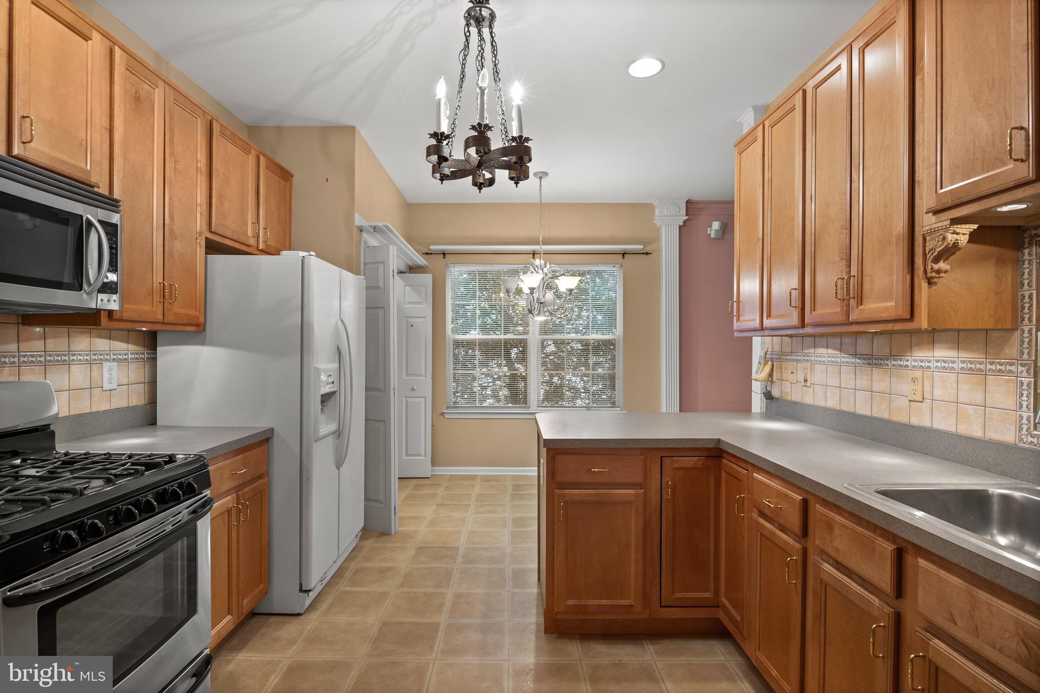 4 Tara Lane Delran, NJ 08075 - Photo 11 of 36 a kitchen with stainless steel appliances granite countertop a sink stove and refrigerator