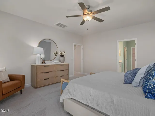a bedroom with a large bed and a chandelier