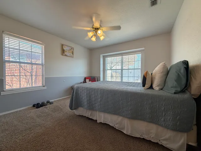 a spacious bathroom with a double vanity sink a mirror and a shower