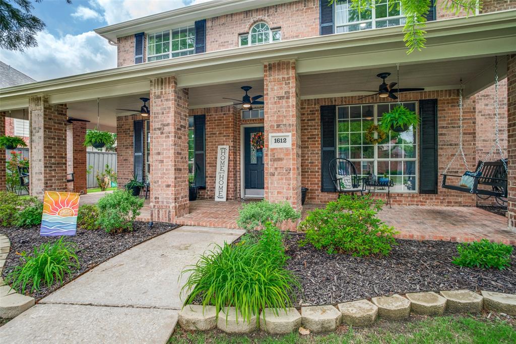 1612 Coventry Lane Allen, TX 75002 - Photo 35 of 39 Brick exterior featuring a covered porch with column supports, ceiling fans, and a swing