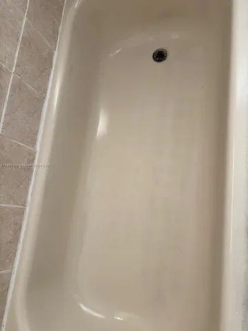 a view of a livingroom with a fireplace and window