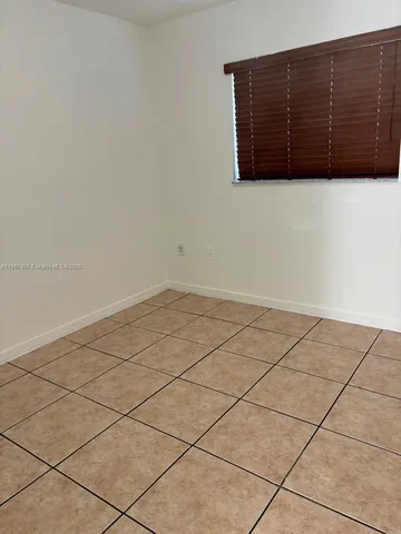 a white bath tub sitting next to a white toilet and vanity
