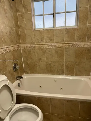 a view of a utility room and empty room