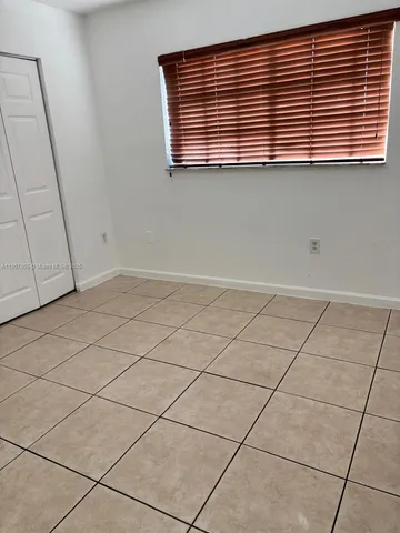 a view of an empty room and a window