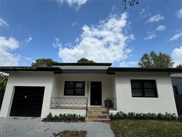 front view of a house with a yard