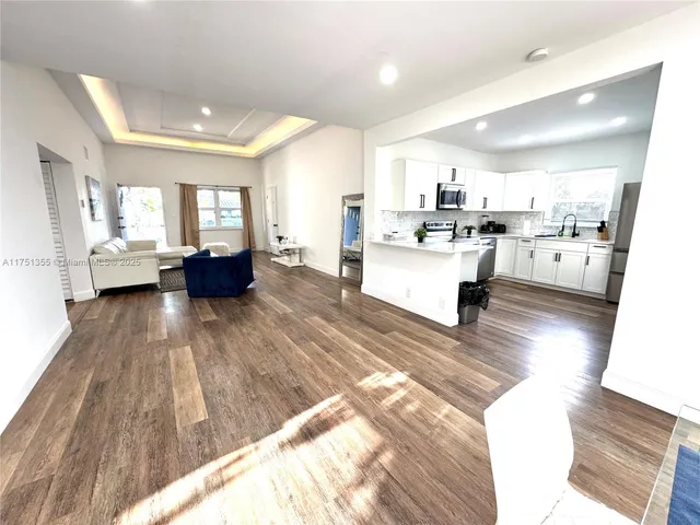 a view of kitchen with sink and living room