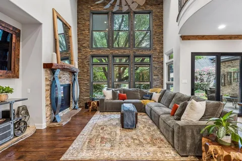 a living room with fireplace furniture and a large window