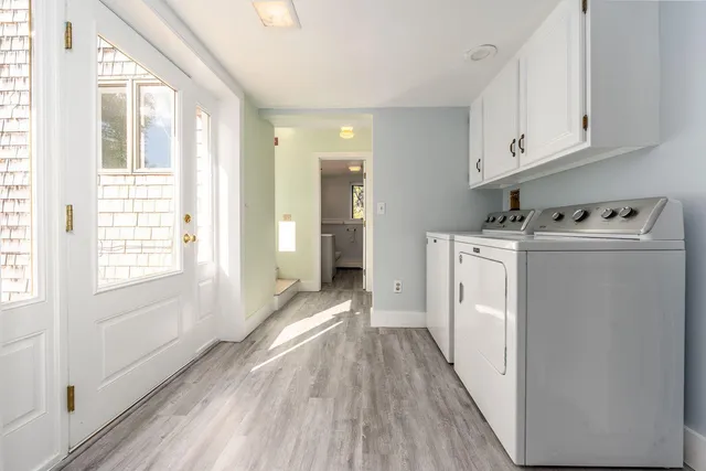 a view of a kitchen with wooden floor and electronic appliances