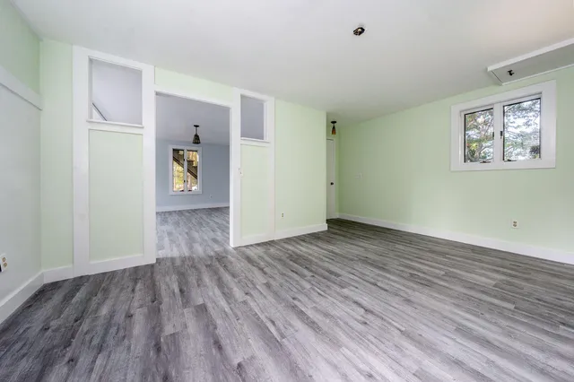 a view of an empty room and wooden floor