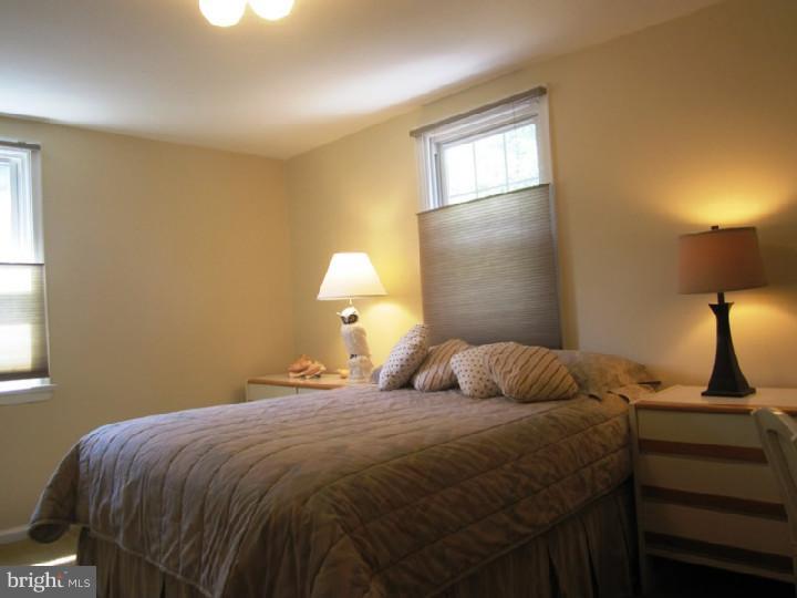 320 Gribbel Road Wyncote, PA 19095 - Photo 13 of 24 a bedroom with a bed and a lamp