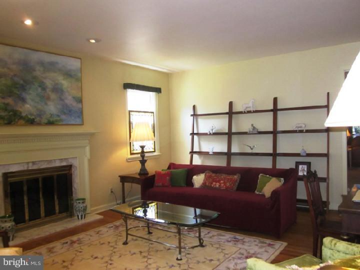 320 Gribbel Road Wyncote, PA 19095 - Photo 3 of 24 a living room with furniture a window and a fireplace