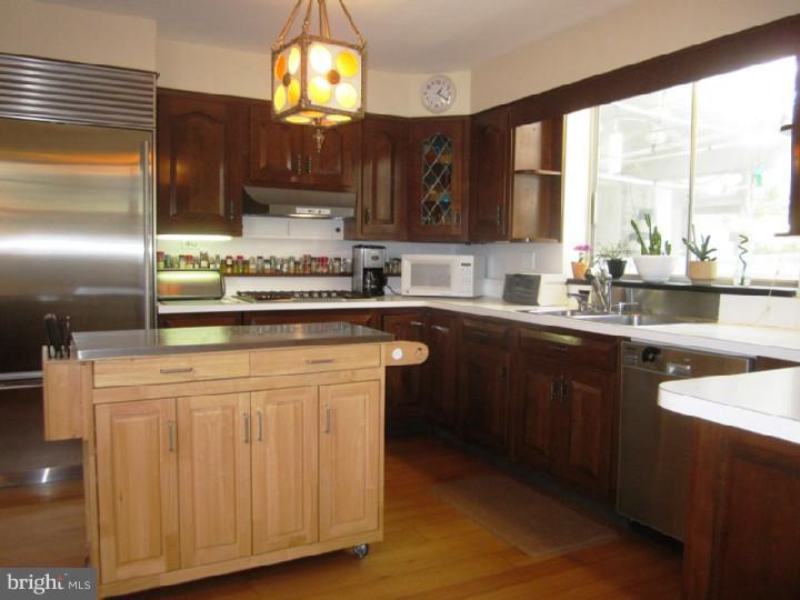320 Gribbel Road Wyncote, PA 19095 - Photo 4 of 24 a kitchen with stainless steel appliances granite countertop a stove a sink dishwasher and a microwave