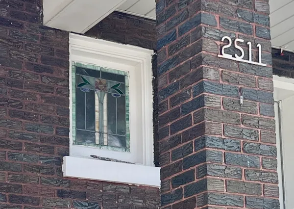 a view of a brick house with many windows
