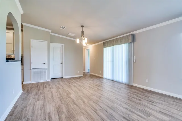 a view of a room with wooden floor and window