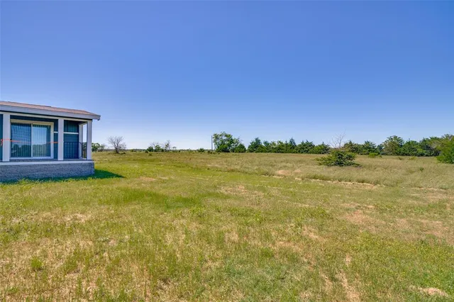 a view of a lake with a house in the background