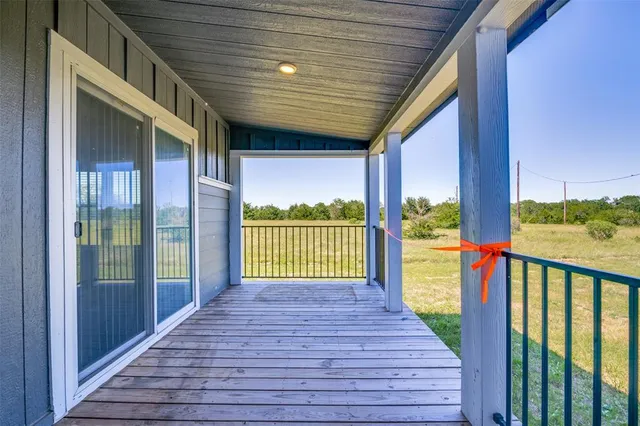 a view of a balcony with wooden floor