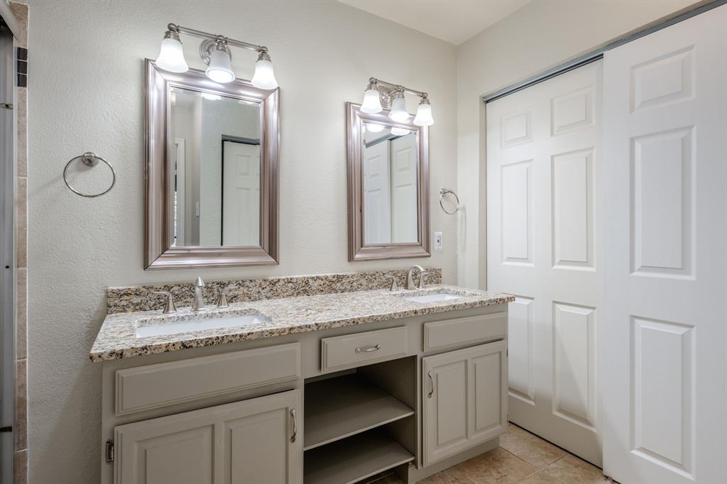 5200 Martel Avenue, Unit 37C Dallas, TX 75206 - Photo 12 of 26 a bathroom with a double vanity sink and a mirror