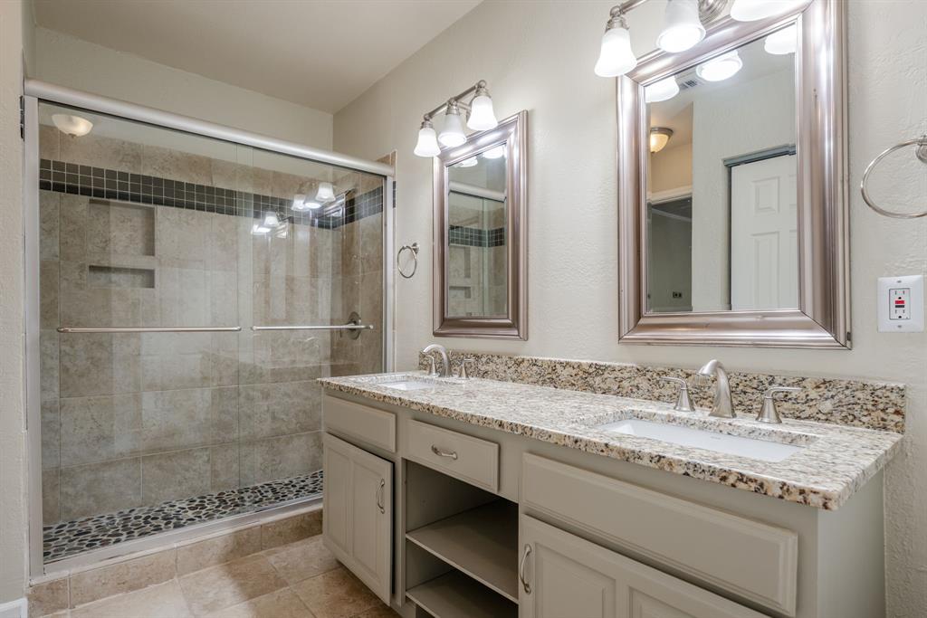 5200 Martel Avenue, Unit 37C Dallas, TX 75206 - Photo 13 of 26 a bathroom with a granite countertop shower sink and mirror