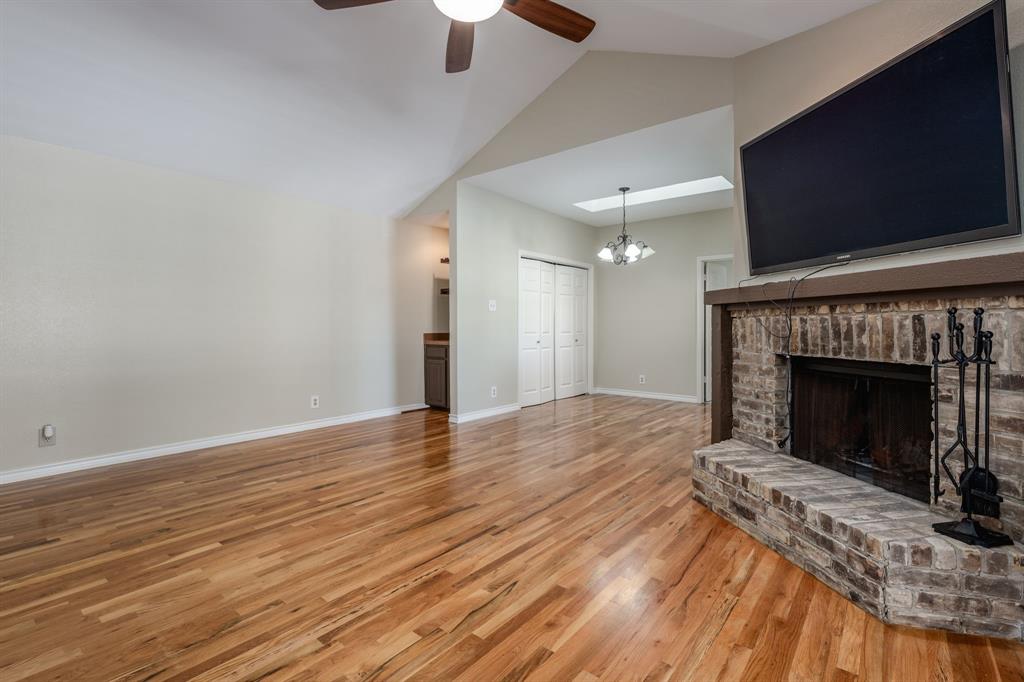 5200 Martel Avenue, Unit 37C Dallas, TX 75206 - Photo 3 of 26 an empty room with wooden floor a fireplace